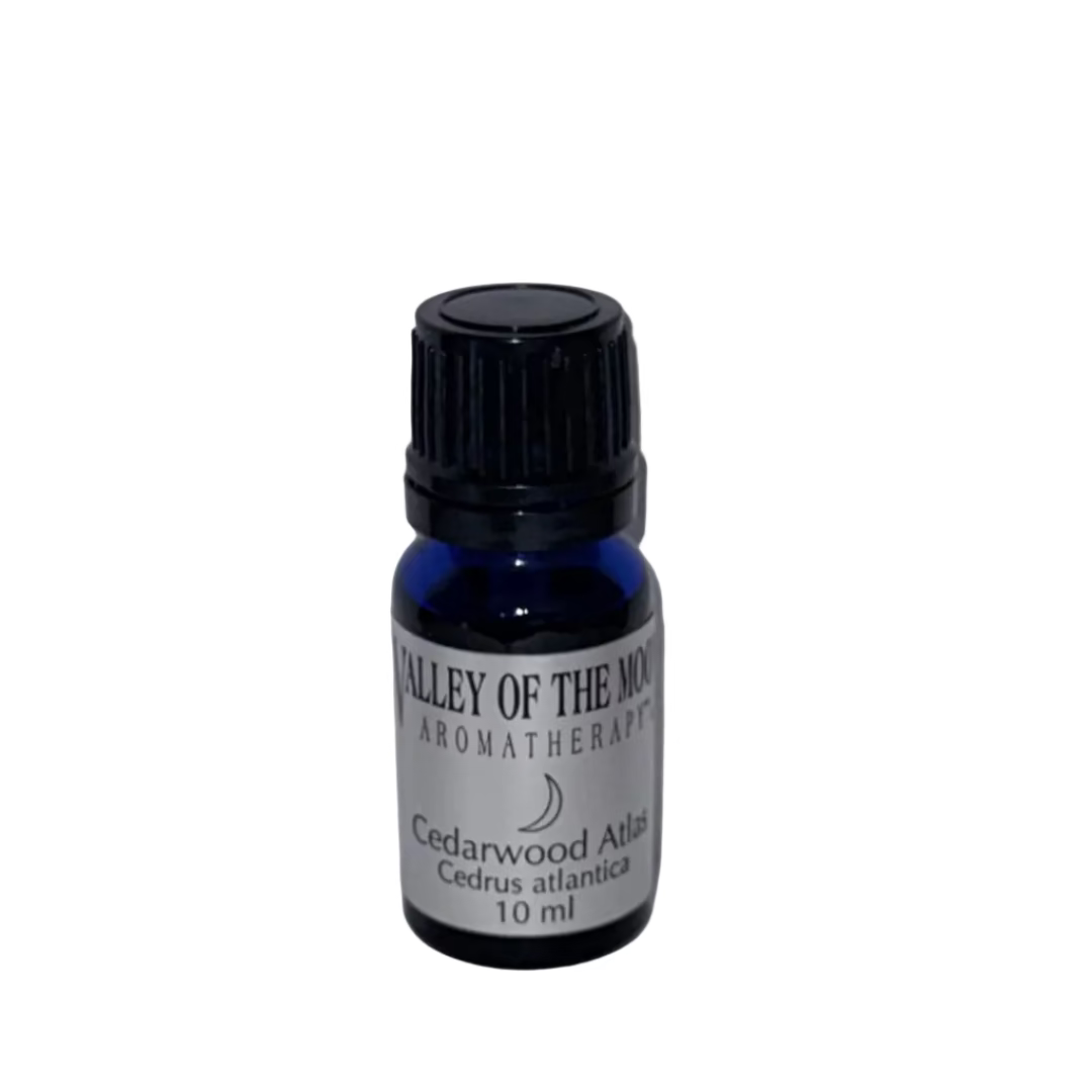 Small bottle of Valley of the Moon Aromatherapy Cedarwood Atlas essential oil on a gray background