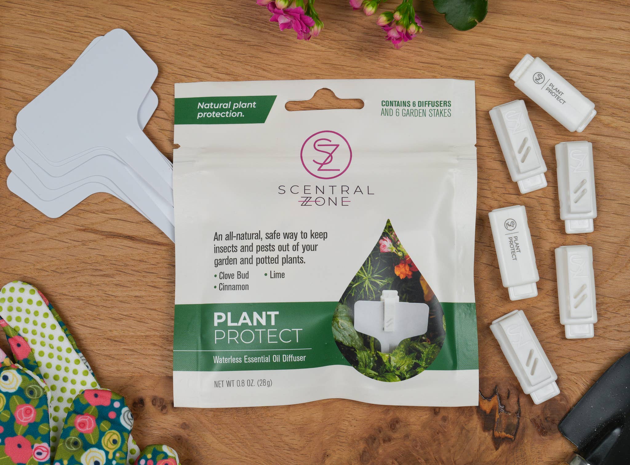 Scentral Zone Plant Protect packaging on a wooden surface with 6 stake essential oil diffusers 