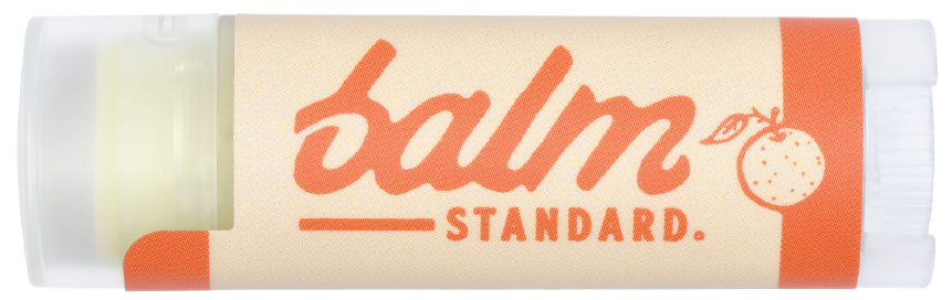 Lip balm stick with 'balm standard' branding on a white background